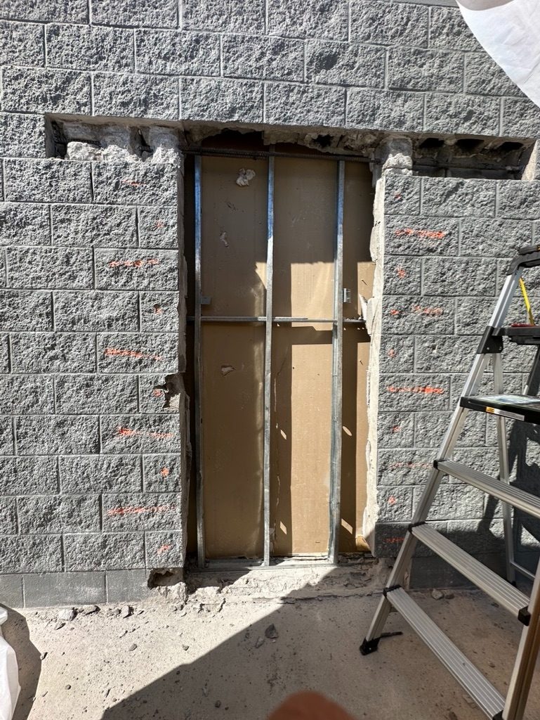 Stone masonry exterior with door framing