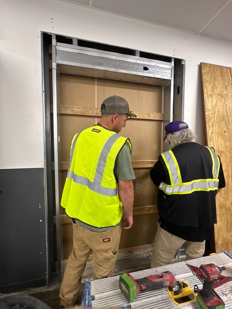 Reform crew installing commercial Walmart door