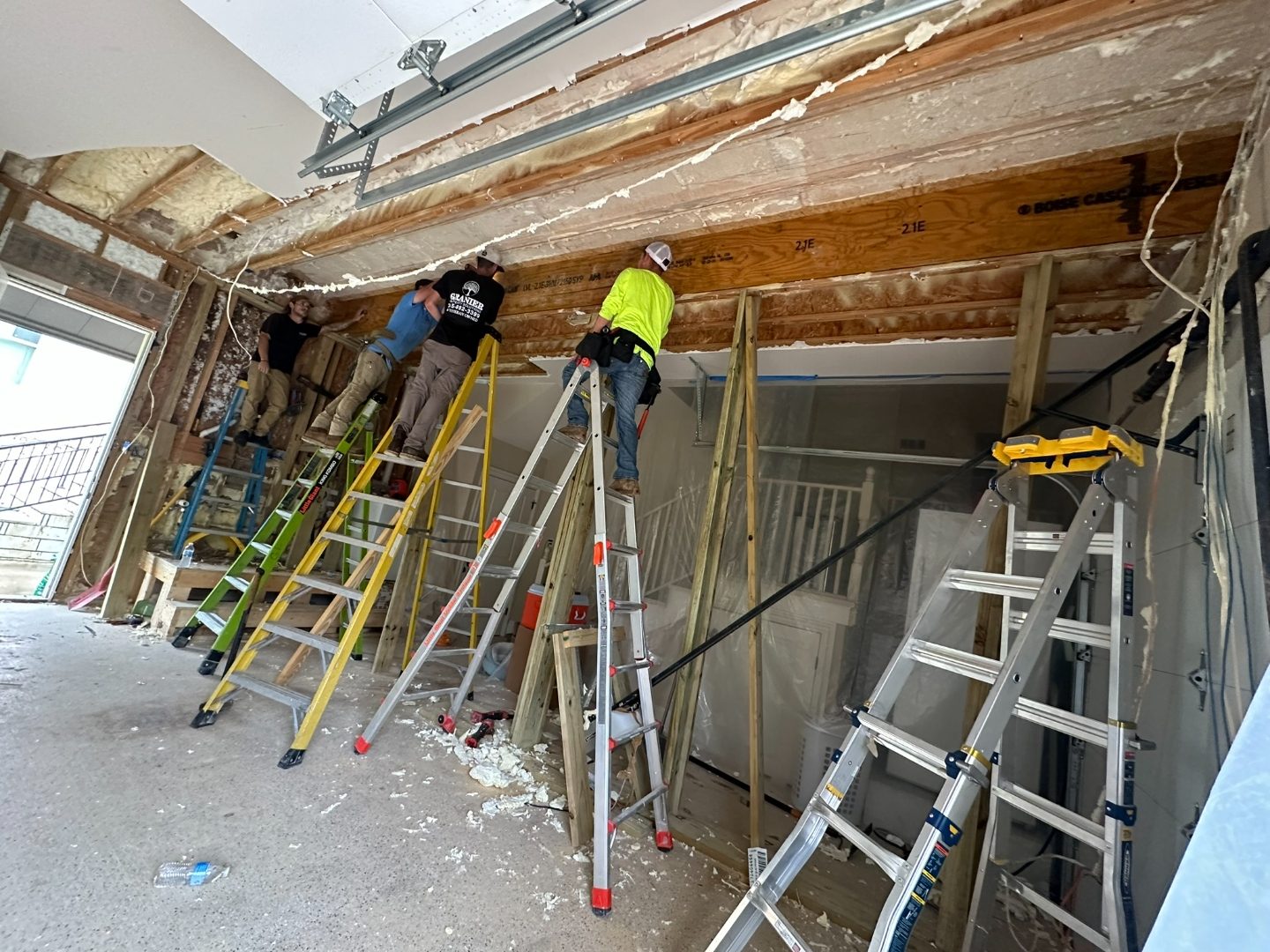 Interior framing and restoration with crew on ladders