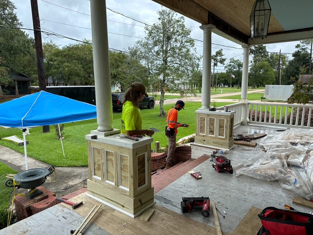 Reform Construction crew rebuilding front porch columns